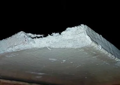 Damaged asbestos insulating board (AIB) panel